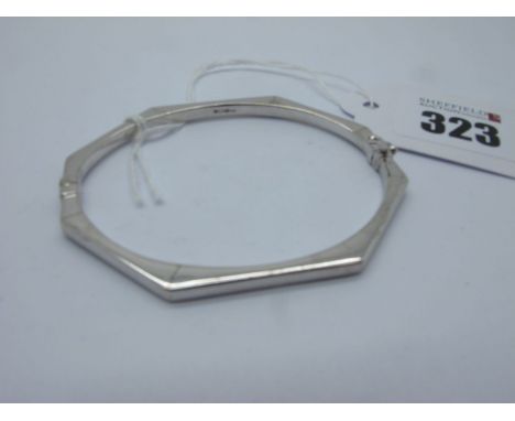 A Modern 9ct White Gold Hinged Bangle, of elongated octagonal design (sprung hinge) (overall weight 6.4grams). 