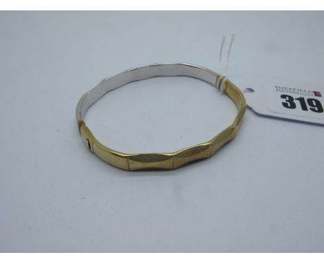 A Modern 9ct Two Colour Gold Hinged Bangle, of textured and polished finish (10.5grams). 
