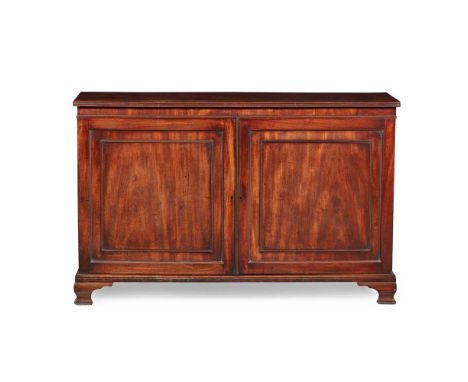 the top with a reeded edge over a pair of panel doors opening to sliding trays, raised on ogee bracket feet141cm wide, 90cm h