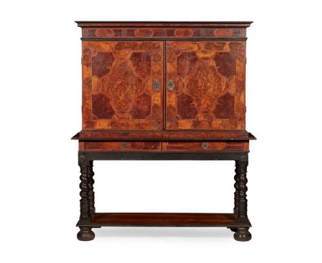 the moulded cornice above a pair of parquetry doors inlaid with cartouches, strapwork and architectural niches to the sides, 