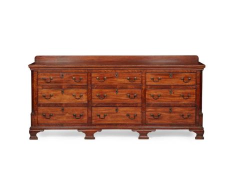 the top with a ledge back and moulded edge over an arrangement of nine short drawers, flanked by quarter columns, raised on o