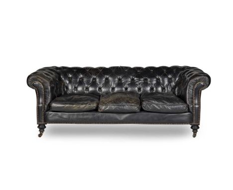 traditional form in black button upholstered leather, on turned legs with ceramic castors201cm wide, 68cm high, 56cm deepProv