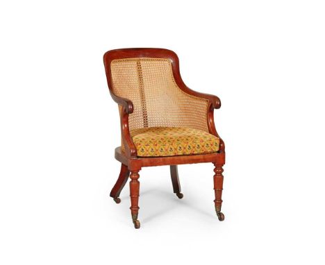 with a caned back and seat with loose cushion, raised on turned and tapered legs ending in brass caps and ceramic and wood ca