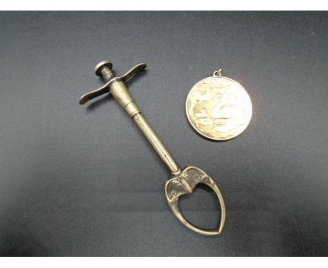 A (plated) Art nouveau push button sugar/olive tong for cocktails/food serving and a hallmarked swan and signet medal engrave