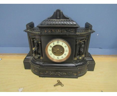 A high black slate mantel clock with gilt detail and enamel face