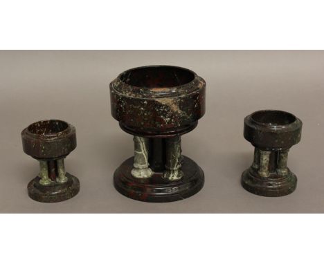 A PAIR OF CORNISH SERPENTINE FONTS, the circular basin on four turned columns around a central support, on outswept circular 