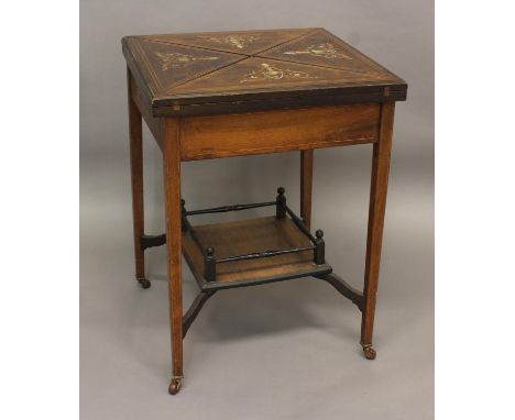 AN EDWARDIAN ENVELOPE ROSEWOOD CARD TABLE, the top inlaid with scrolling floral urns enclosing a baize-lined interior, above 