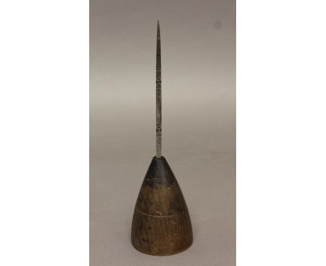 AN 18TH CENTURY OR EARLIER PRICKET CANDLE STICK, with a point shaft decorated with dots and 'X' motifs, on a spreading domed 