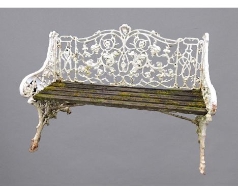 A CAST IRON GARDEN BENCH, the branch effect back cast with scrolling leaves and flowers, length 135cm