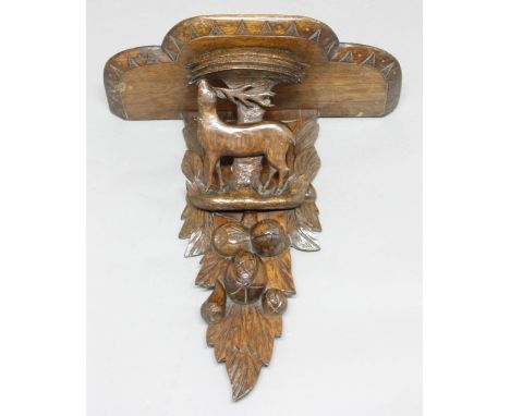 BLACK FOREST CARVED OAK BRACKET, mid 19th century, the shaped shelf above a stag and fruit, height 52cm, width 49cm, depth 25