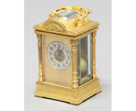 FRENCH GILT BRASS FOUR PANE CARRIAGE CLOCK, the silvered dial with arabic numerals and foliate centre on an eight day repeate