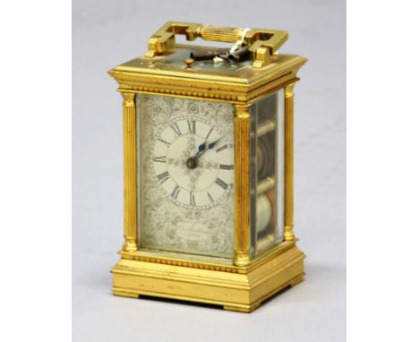 GILT BRASS FOUR PANE CARRIAGE CLOCK, the silvered dial inscibed Chas. Frodsham beneath roman numerals and engraved scrolling 