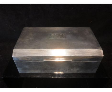 A silver mounted cigarette box, rectangular the engine turned cover with arched top, Birmingham 1935, makers mark of R &amp; 