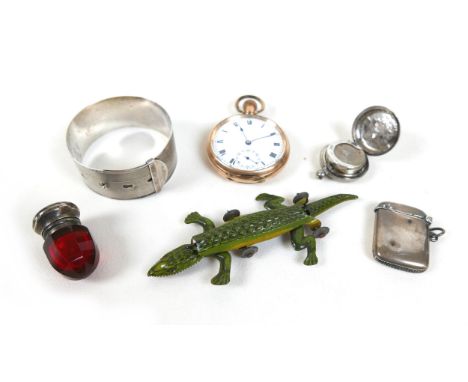 A silver buckle, silver vesta, silver sovereign holder, cranberry glass sifter, gold plated pocket watch and a tinplate croco