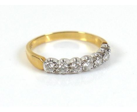 An 18ct gold seven stone diamond ring, each round cut stone approximately 2.5mm diameter, size O, 2.7g. 