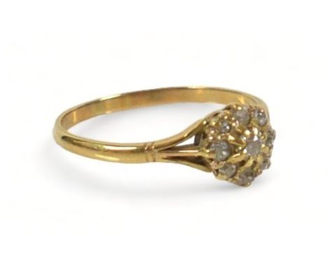 An 18ct gold diamond daisy ring, the largest central round cut stone approximately 3mm diameter, surrounded by eight smaller 