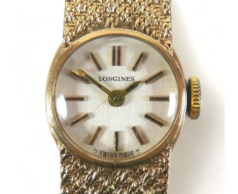 A vintage Longines 9ct gold lady's cocktail watch, circular silvered dial, black and gold batons and hands, on an integral fa