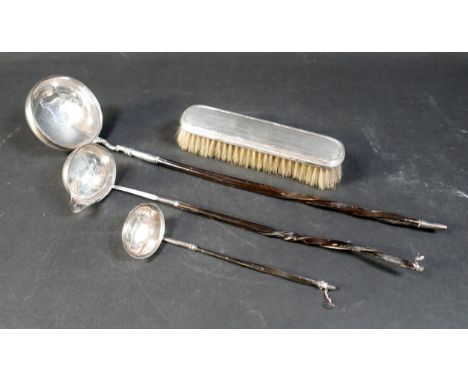 Three silver toddy ladles, the smallest ladle, 18cm long overall, the middle sized ladle, 31cm long overall, both with silver