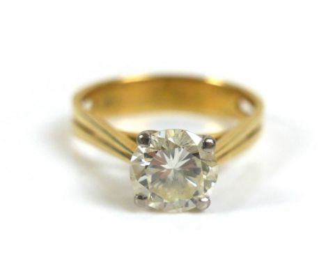 An 18ct gold 1.55ct diamond solitaire ring, the round faceted cut stone, 7.6 by 4.5mm, in four claw white gold setting to a y