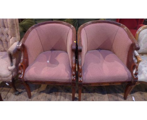 Ornately carved pair of mahogany framed bow backed saloon chairs, the shaped padded backs and seat upholstered in patterned p