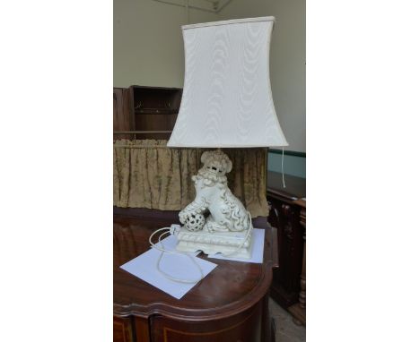 Pair of electrical converted mantelpiece/table lamps each in the form of a roaring lion each on rectangular plinth with cream