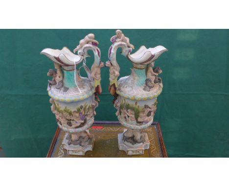 Pair of ornate European mantelpiece jug vases decorated cherubs