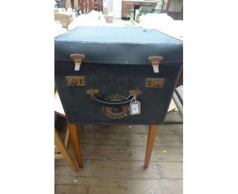 Black carrying case containing a selection of vintage fabric