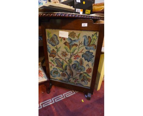 Oak framed fire screen the glass front with floral embroidery behind