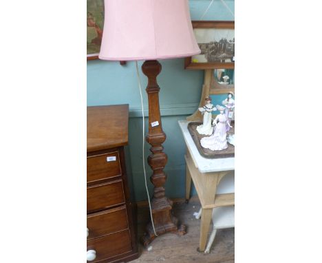 Ornately carved oak lamp standard with pink parchment shade