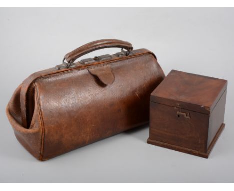 An old leather Gladstone bag and set of chemist scales with metric weights, box with homeopathic bottles