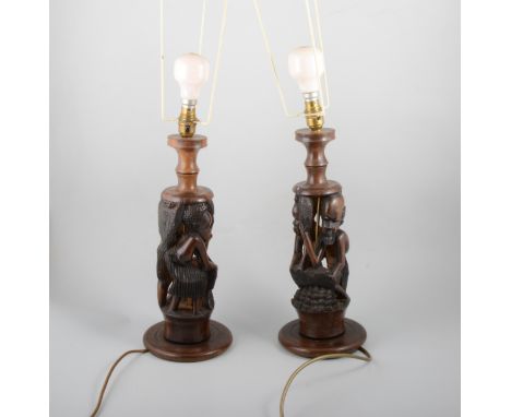 Pair of carved wood African lamp bases, a vintage soda siphon, mantle clock and other lamp bases.