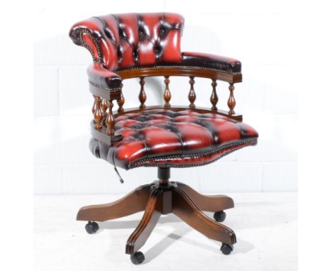 Reproduction beech framed Captain's chair, swivel seat on four splayed legs, button leather upholstery, width 62cm.