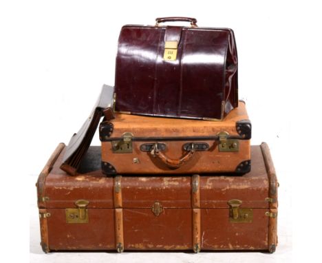 Large bound travelling trunk, stiffened canvas, together with a smaller travelling trunk, a leather briefcase and a matching 