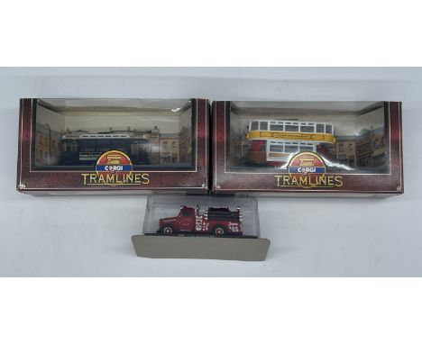 A collection of 3 model cars,
a fire engine,
2x Corgi trams