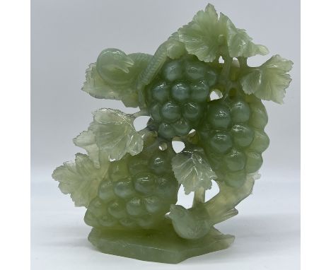 A Jade carving bird with fruit and leaves,
approx 2.5kg,
9 1/2 inches x 9 inches,
some leaves are damages