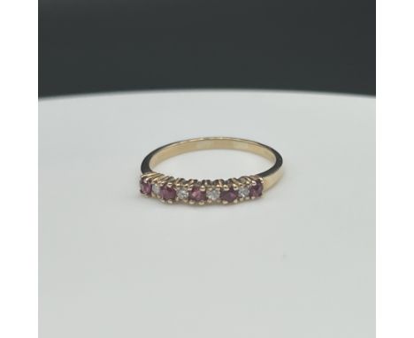 9ct yellow gold ruby and diamond eternity ring,
size Q,