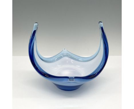 Light blue glass with white interior with winged arms. Issued: 21st centuryDimensions: 6.25"L x 6"W x 6"HCondition: Age relat