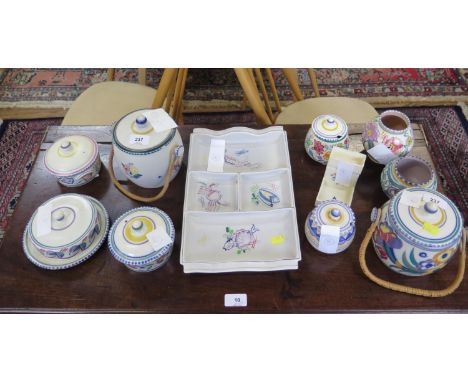 A collection of Poole Pottery, including two biscuit barrels, serving dish with seafood design, jars and lidded jam pots, mos