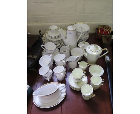 An Art Deco Tuscan China coffee service, with green and orange line decoration on a cream body, six place settings and a late