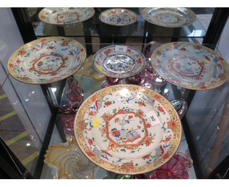 A set of three Chinese porcelain plates, with enamel decoration of a book and vase with red octagonal floral panels within a 