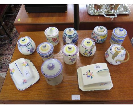 Ten Poole Pottery lidded jam pots and two cheese covers, all with floral designs 