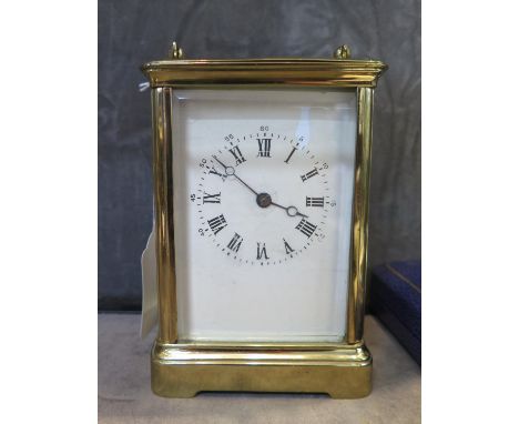 An early 20th century brass carriage clock, of conventional form with enamel dial, the twin train movement striking on a gong