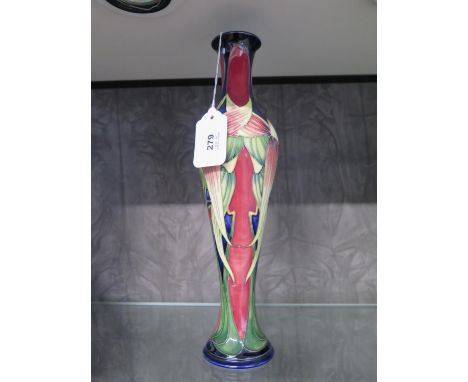 A Moorcroft Pottery slender Trinity pattern vase, signed by Philip Gibson and numbered 266, 31.5 cm high 