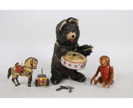 A collection of vintage clockwork and tinplate toys including a Drumming Bear which is approx 20 cm tall and made in Japan bu