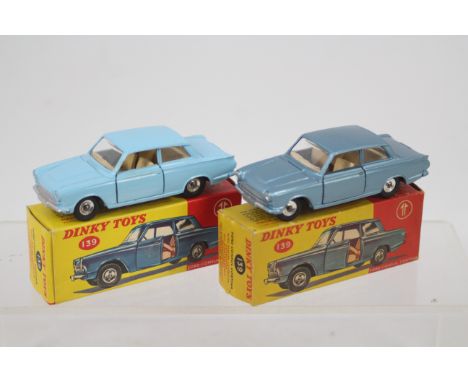 Dinky - 2 x boxed Ford Cortina Mk1 models # 139, one in light blue and one in metallic blue. The cars appear in Very Good con
