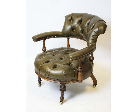 LOW LIBRARY ARMCHAIR, 74cm H x 68cm, Victorian walnut, circa 1860, in buttoned leather on ceramic castors. 