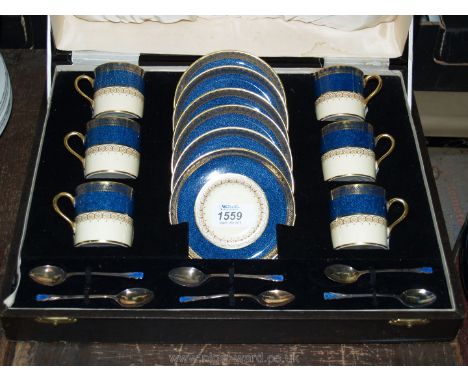 A cased set of Aynsley coffee cups and saucers with matching Silver teaspoons, enamelled in blue and gold.