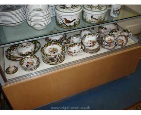 A comprehensive set of Staffordshire Dinner service with oriental style pattern with floral border on green ground, central f