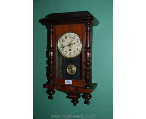 A wooden Oak Wall Clock having Arabic numerals (with key)