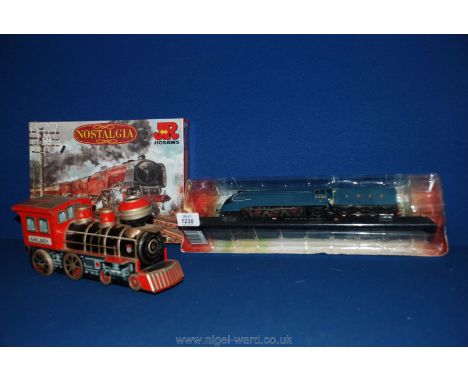 A 00 gauge model of ' Mallard', in sealed box, along with a sealed train jigsaw and a vintage tinplate toy train.